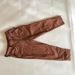 Nike Tech pack pants in rust color. Slightly cropped.